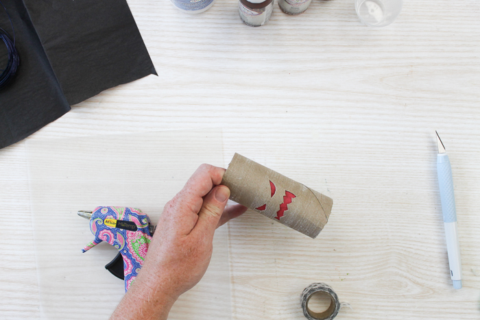 adding paper inside a toilet paper roll