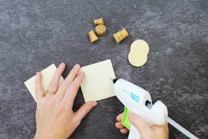 adding hot glue to a piece of wood