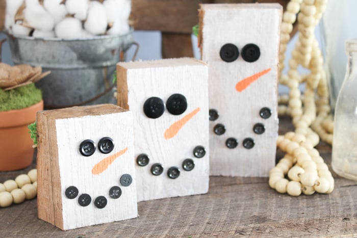 button eyes on a wood snowman