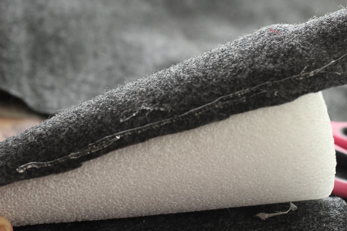 Secure the felt fabric around the styrofoam cone using hot glue