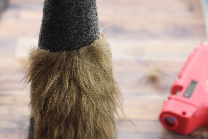 Using hot glue, attach the faux fur beard to the felt-covered Gnome body