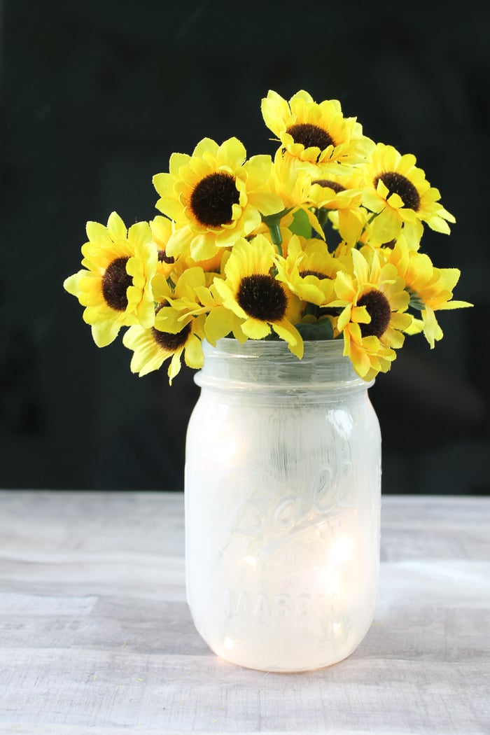 Fairy light lantern with sunflowers.