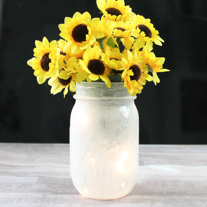 DIY mason jar lantern painted and filled with fairy lights