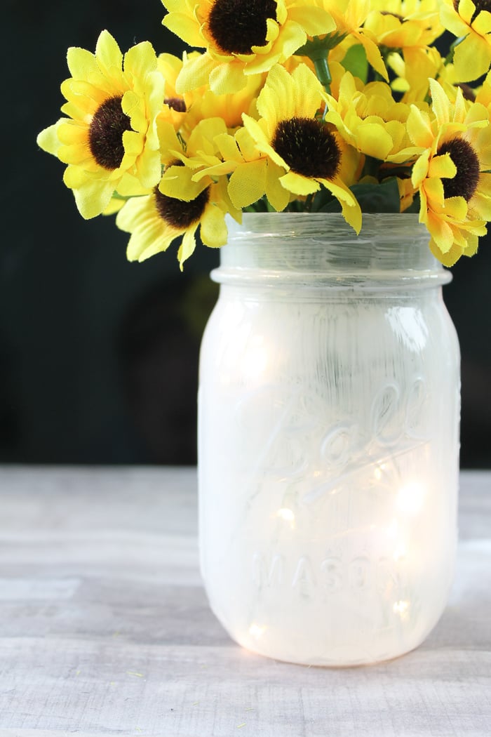 Fairy lights mason jar project with sunflowers.