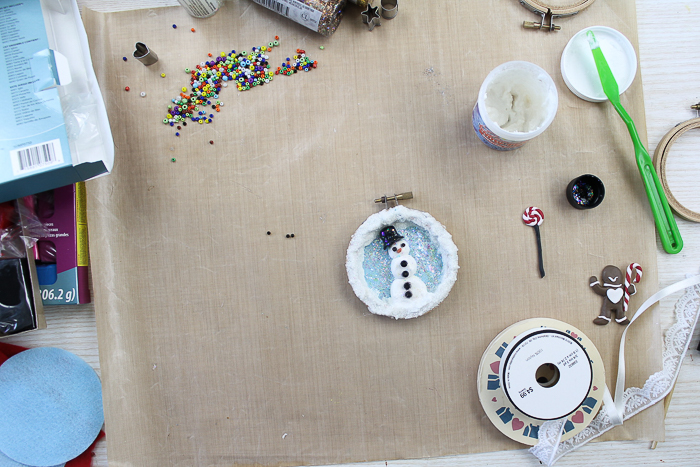 Adding clay pieces to make a Christmas ornament