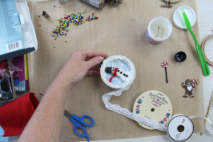 Adding lace around the edges of the Christmas ornament