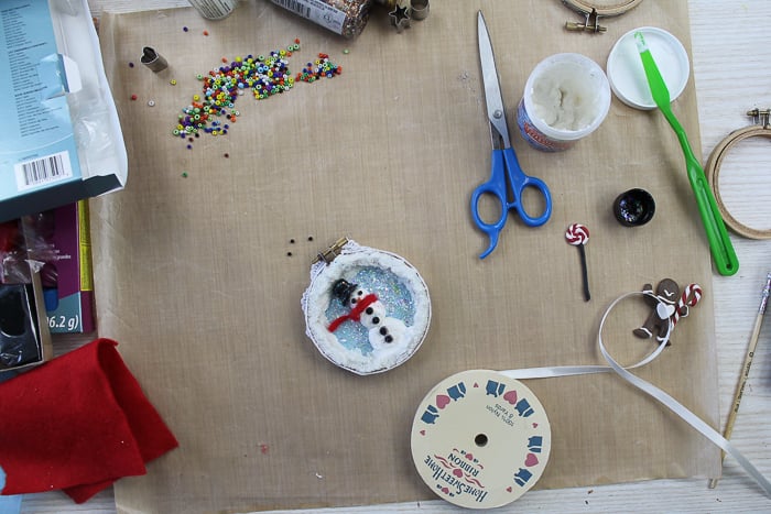 Adding ribbon to a Christmas ornament