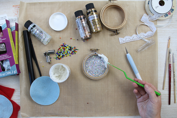 Adding fake snow paint to a Christmas ornament