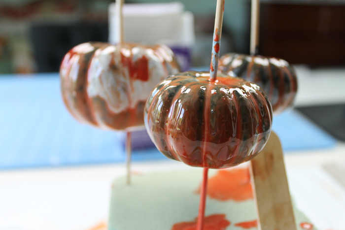 Covering pumpkins in marbled resin finish.