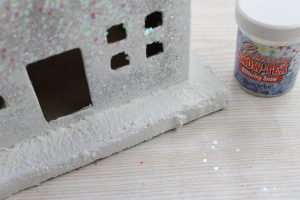 adding fake snow to a house gift box