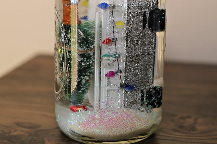 adding water to a mason jar snow globe