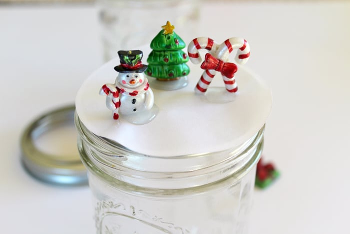 snow globe mason jar topper photo of gluing down the ornaments for the snow globe