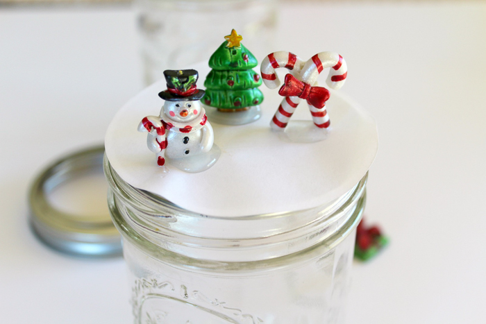 snow globe mason jar topper photo of gluing down the ornaments for the snow globe