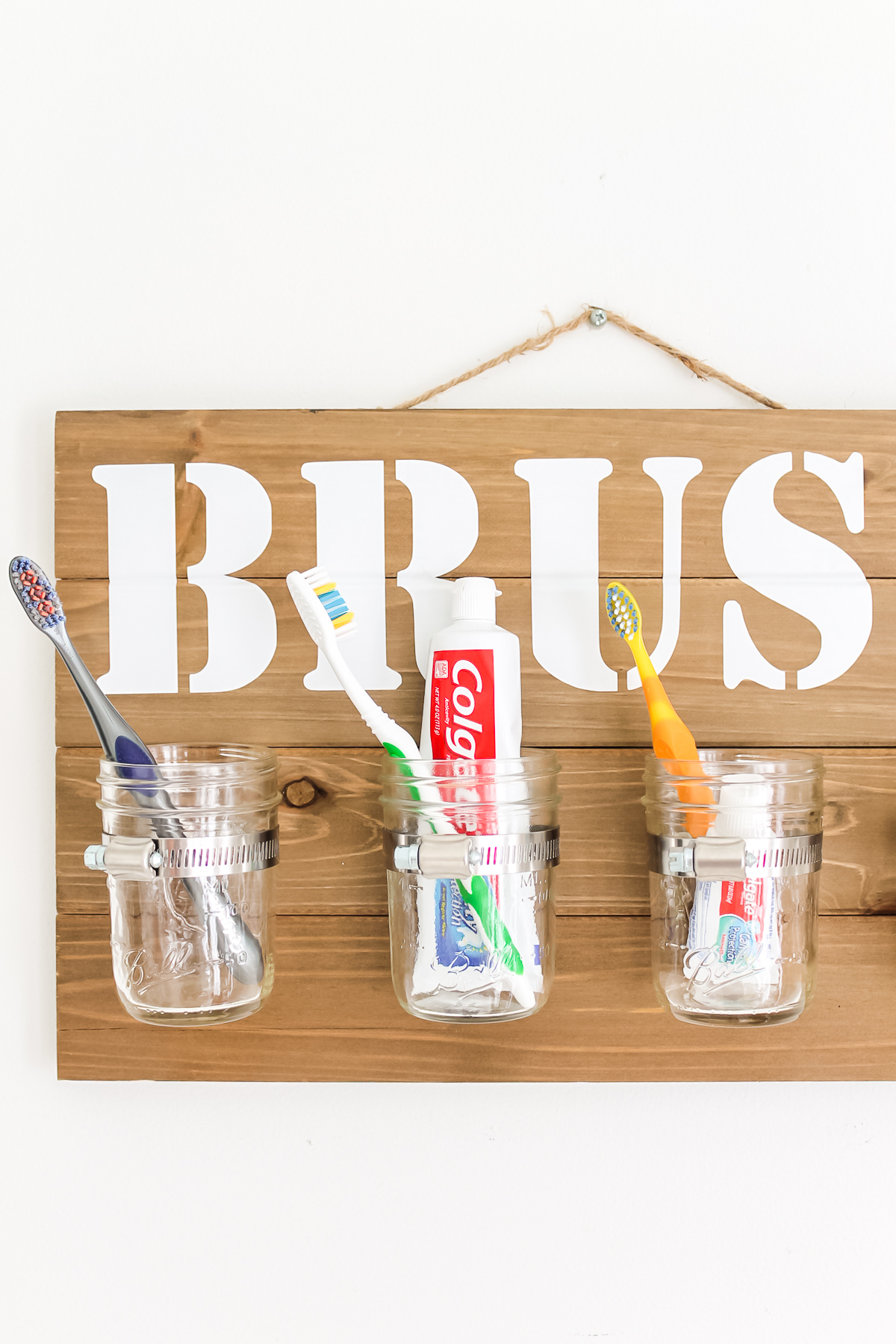 organizer decor for a bathroom with mason jars and a Cricut machine