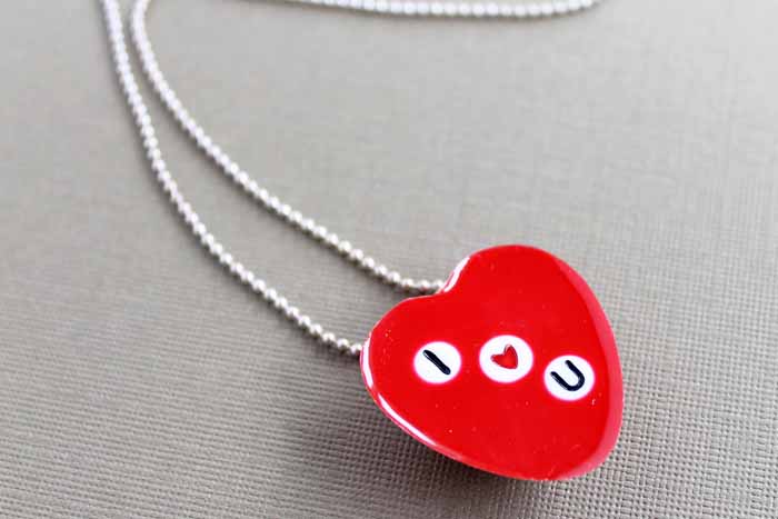 Make this DIY heart necklace with resin for Valentine's Day or anytime of the year! embed beads to read whatever you would like! #valentinesday #necklace #jewelry #resin