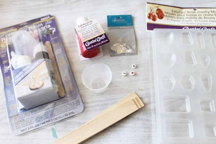 Supplies needed to make a DIY heart necklace with resin.