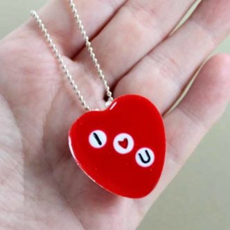 Make this DIY heart necklace with resin for Valentine's Day or anytime of the year! embed beads to read whatever you would like! #valentinesday #necklace #jewelry #resin