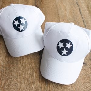 Learn about adding heat transfer vinyl to hats. Post compares three methods including a heat press, EasyPress, and mini iron! #cricut #cricutmade #htv #heattransfervinyl #hats