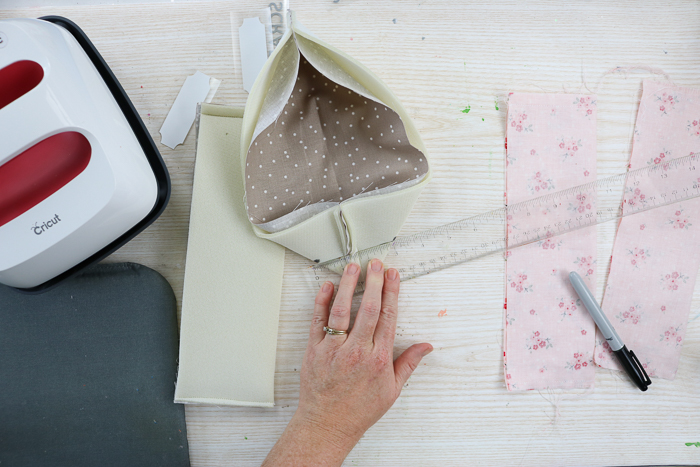 Measuring and marking for sewing line to create fabric storage bins.