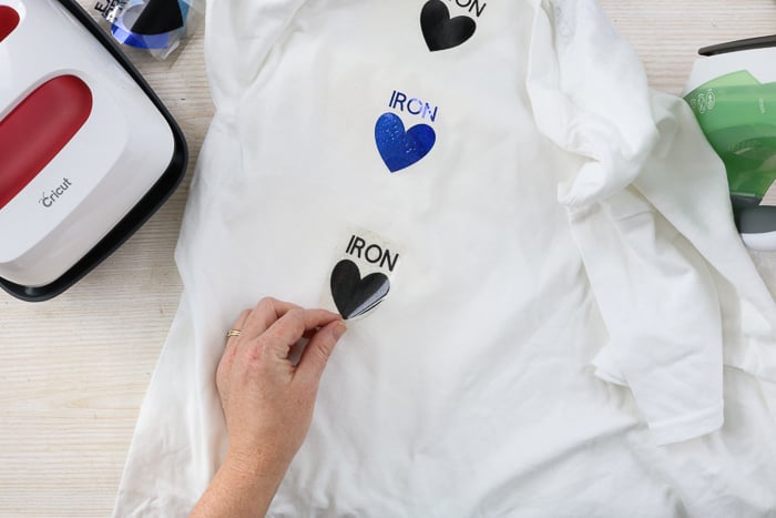 Peeling back carrier sheet on iron-on material that was applied with an iron.