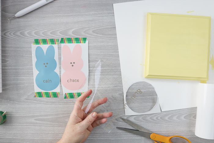 Applying transfer tape to peeps bunnies cut from vinyl.