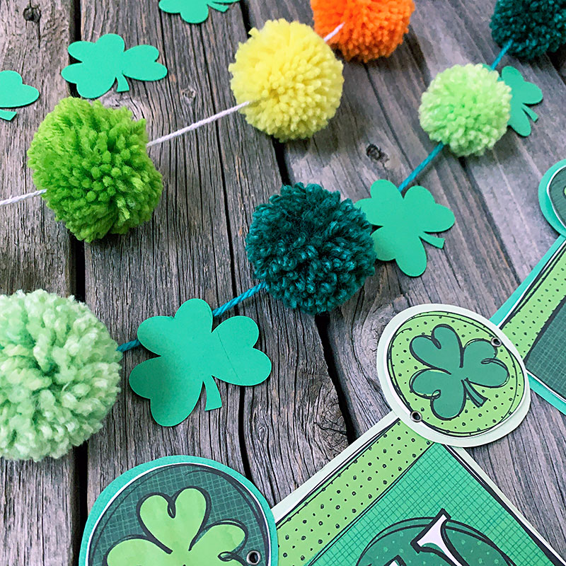 DIY pom pom garland that is perfect for Saint Patrick's Day