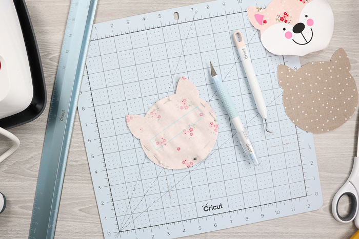 Use Cricut hand tools to make cuts in fabric.