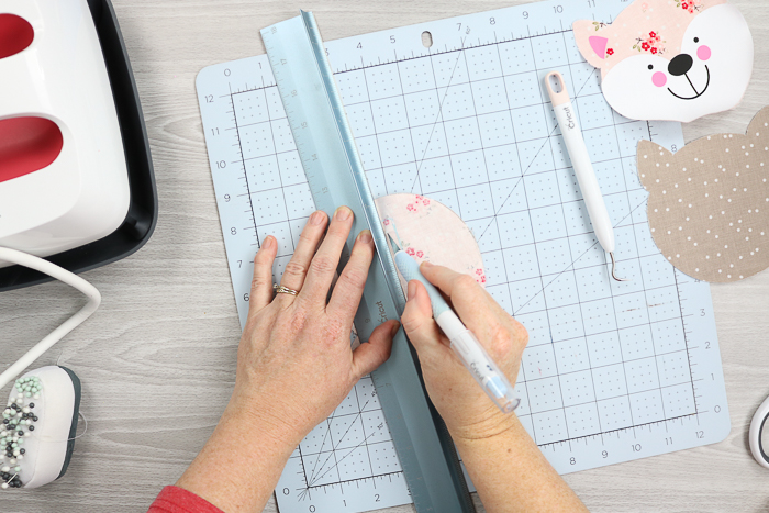 Cutting slit in fabric with Cricut True Control Knife.