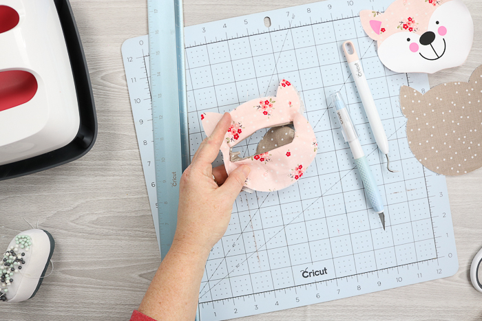 Turning fabric out to make a finished hole for a zipper on the back of a zipper pouch.