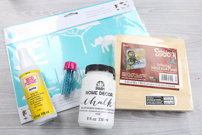 Supplies needed to make glitter wall art, with Mod Podge Ultra