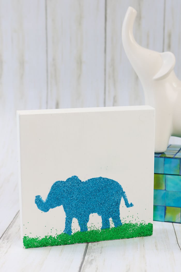 Adding glitter to a piece of elephant art using Mod Podge Ultra