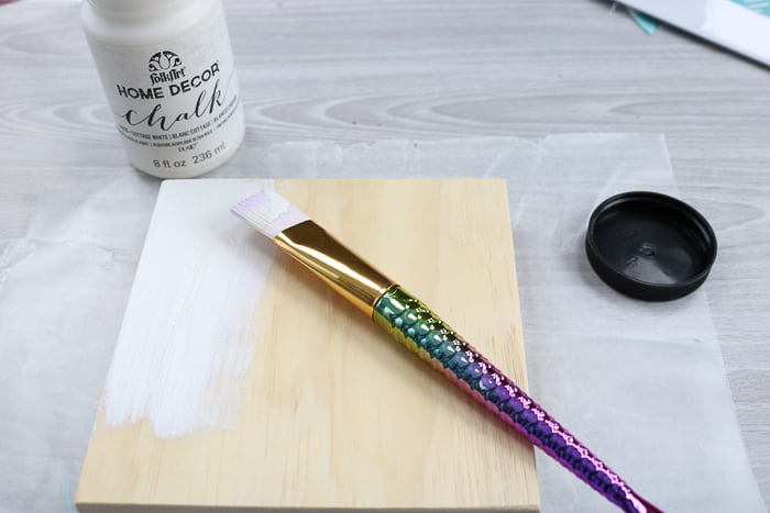 Paint the wood canvas as a base for this glitter art project.