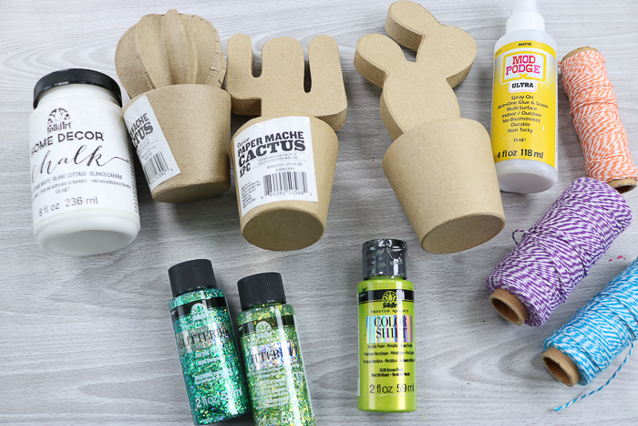 Supplies needed to make a DIY cactus including paper mache cacti and Glitterific paint.