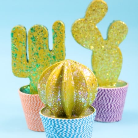 A DIY cactus from paper mache with glitter paint and a decoupage twine pot.