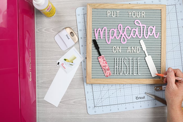 Putting tabs on DIY letter board accessories with hot glue