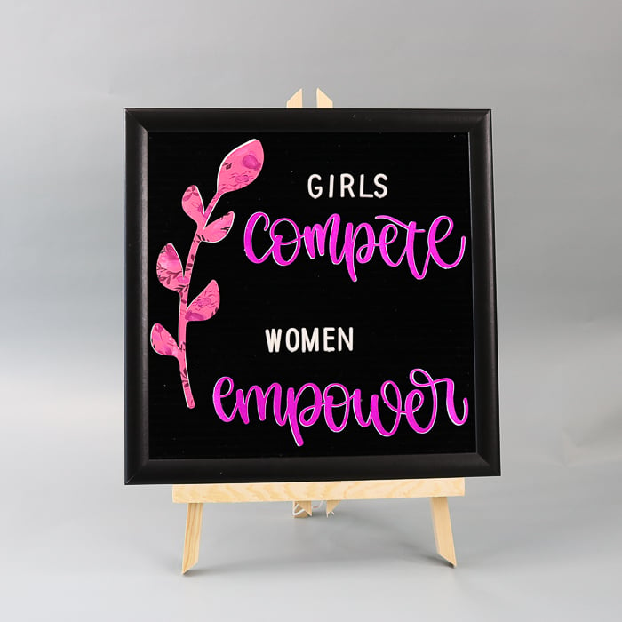 Girls compete women empower quote on a felt letter board