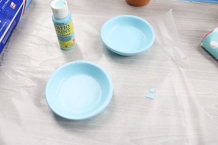 Start by painting the terracotta plater saucers with patio paint