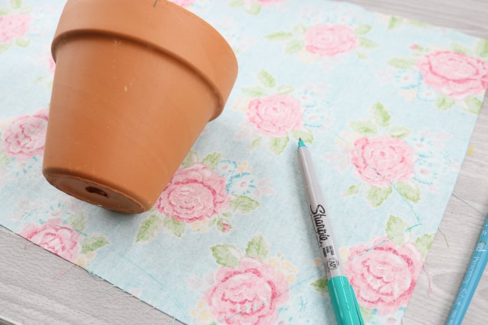 Measure how much fabric you'll need to cover the terracotta planter