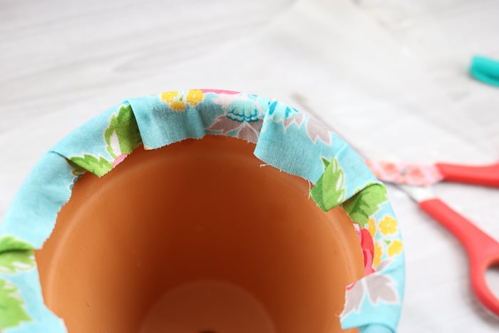 Wrap the Mod Podge fabric over the top edges of the terracotta planter