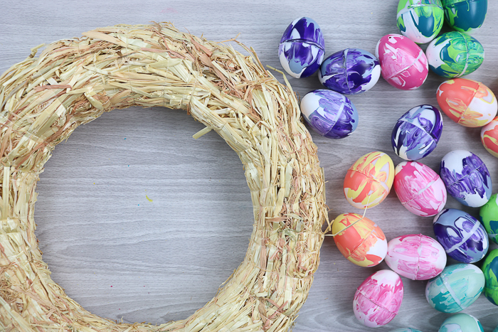 Straw covered wreath form ready for marbled eggs.