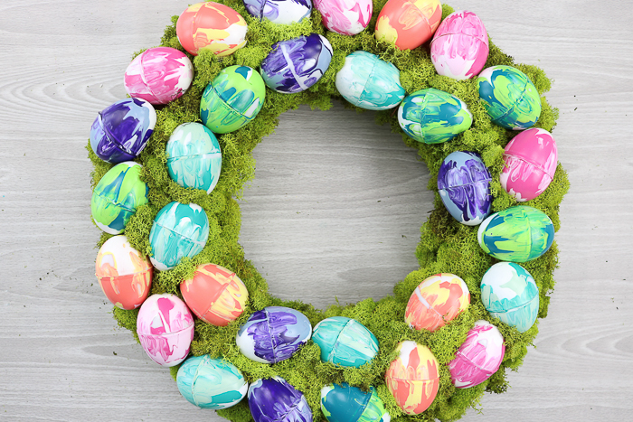 Moss covered spring wreath with marbled Easter eggs.