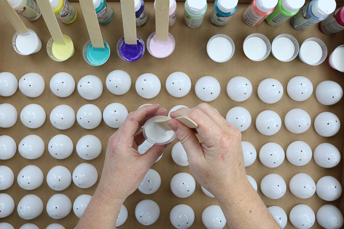 Mixing marbling medium with paint to make marbled eggs.