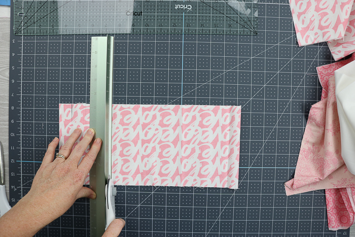 Cutting fabric into strips using the Cricut hand tools.