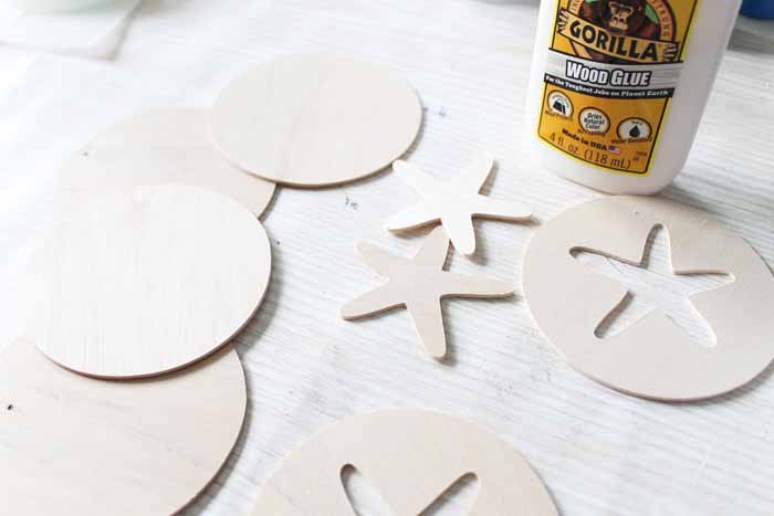 Pieces of wood with cutout starfish shapes made with the knife blade of the Cricut maker.