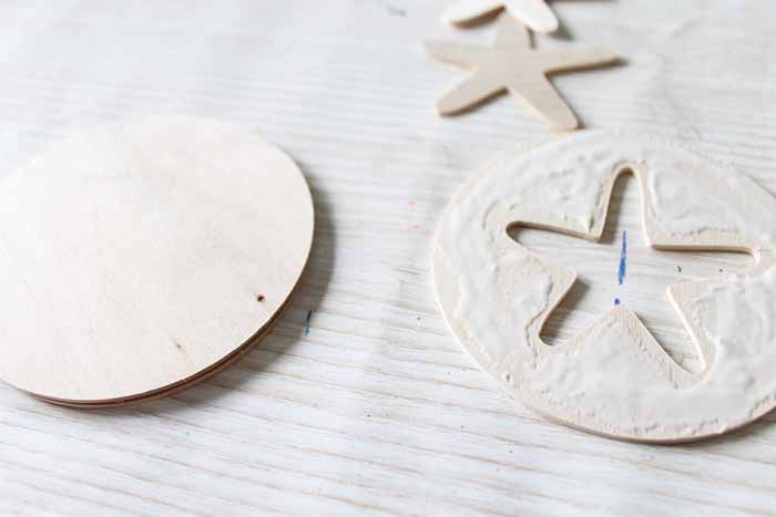 Use wood glue to stack the wood coaster pieces together, with the star coaster on top.