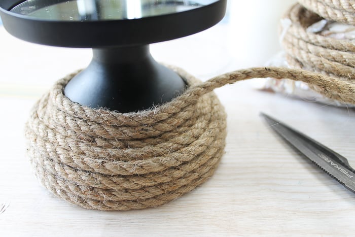 Start by wrapping rope around the base of the candleholder