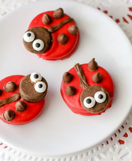 Ladybug decorated cookies on a white plate