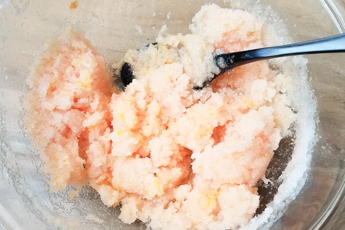 Mixing DIY orange sugar scrub in a bowl