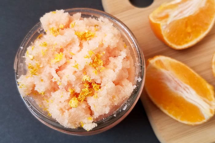 Orange peel sugar scrub in a mason jar ready for gift giving.