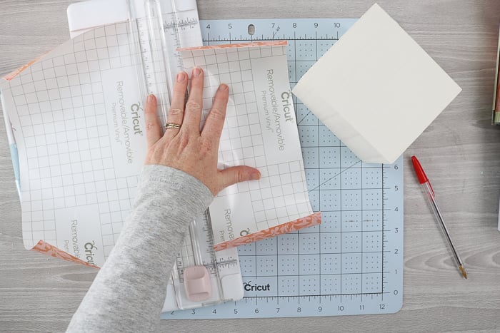 Cutting printed vinyl with a paper cutter.